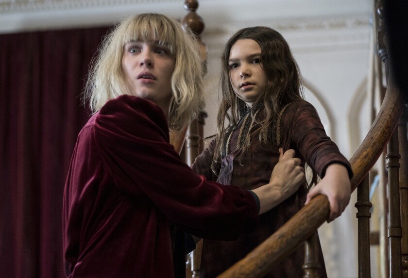 Mackenzie Davis, left, and child actor Brooklynn Prince on a staircase in the movie 'The Turning'
