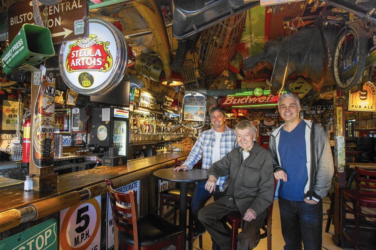 Robert "Zeb" Ziemer, center, is flanked in January 2015 by his adopted sons, Charles Nicholson, left, and Kevin Sand at Goat Hill Tavern, the bar Ziemer opened in Costa Mesa in 1984.