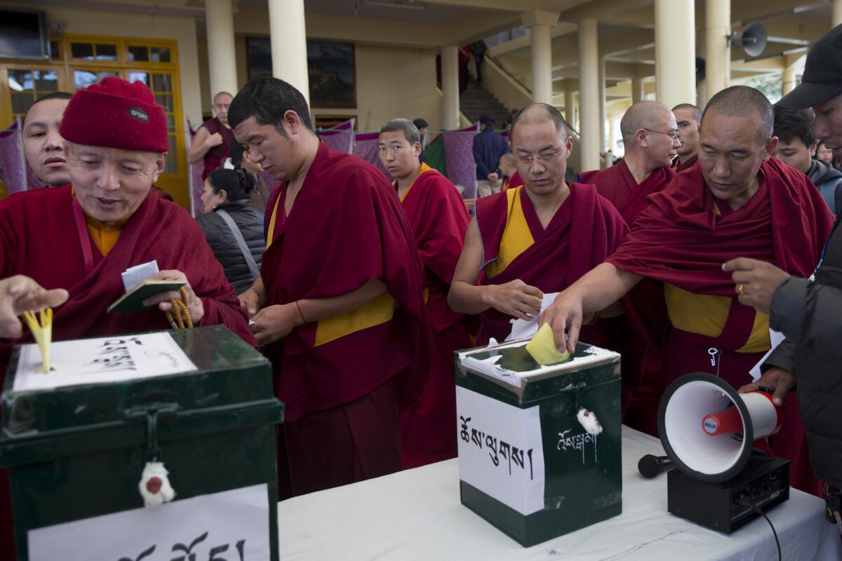 Exiled Tibetan monks cast their votes for the next prime minister and parliamentarians in Dharamsala, India.