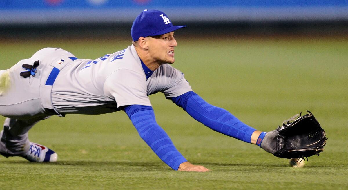 Dodgers left fielder Trayce Thompson fails to make a diving catch on a ball hit by the Angels' Rafael Ortega in the fifth inning.