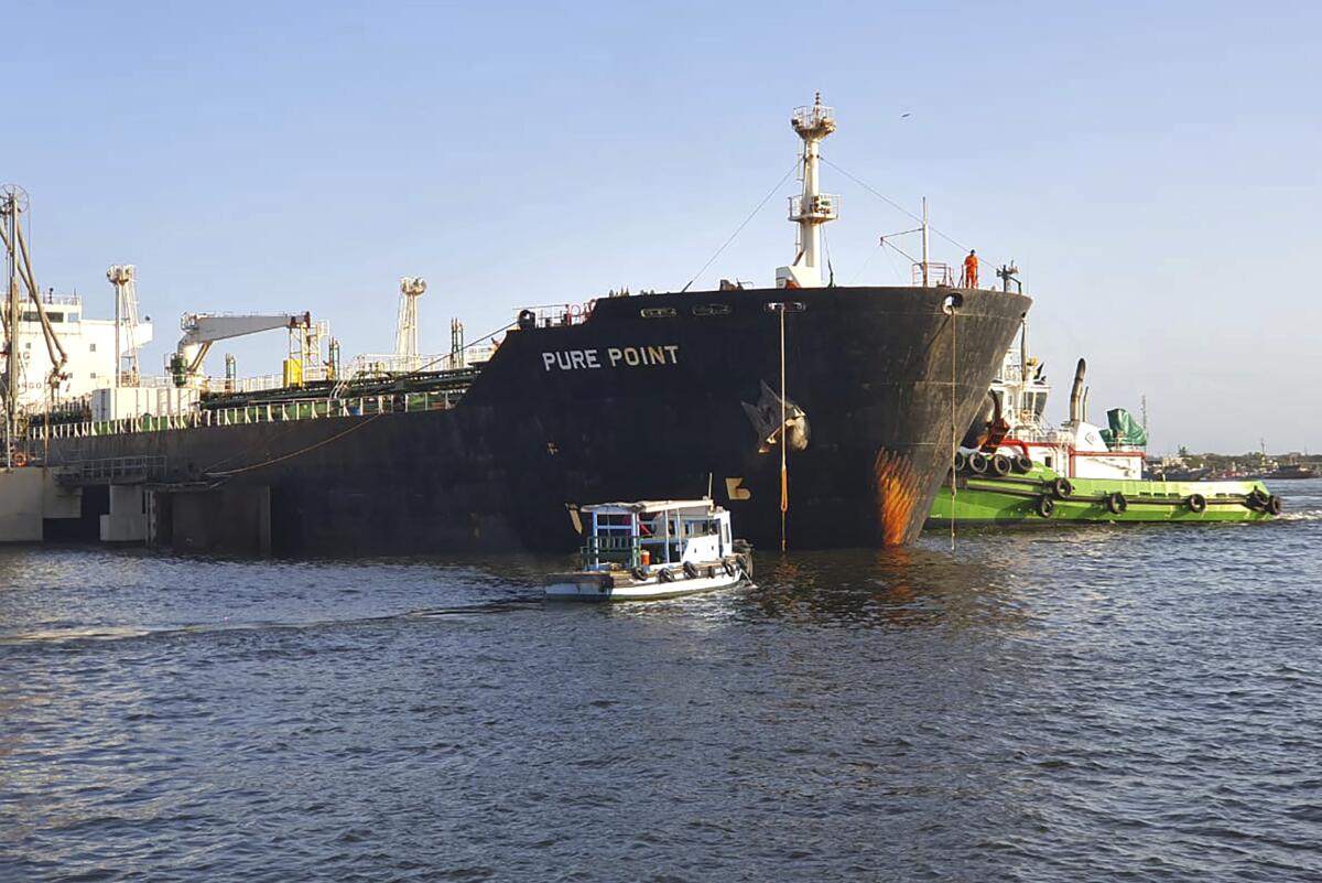 A Russian cargo ship carrying discounted crude oil is anchored at a port.