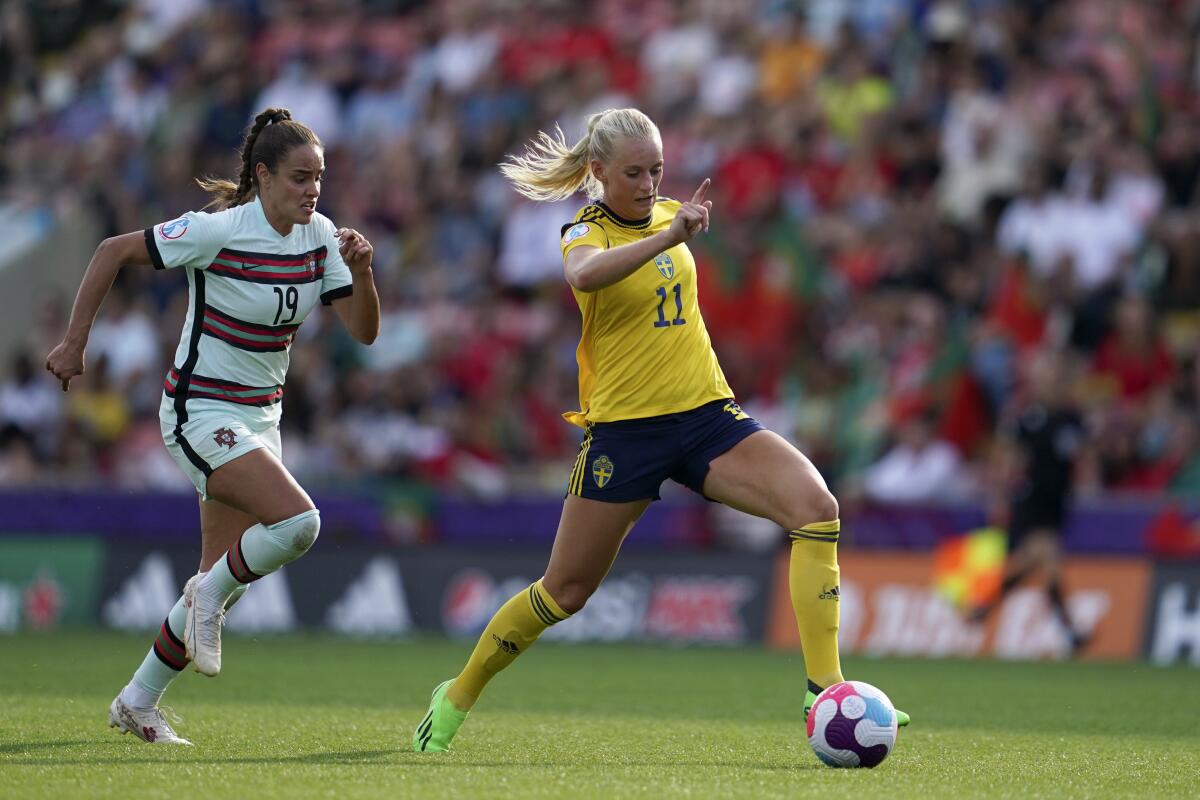 Sweden's Stina Blackstenius controls the ball in front of Portugal's Diana Gomes.
