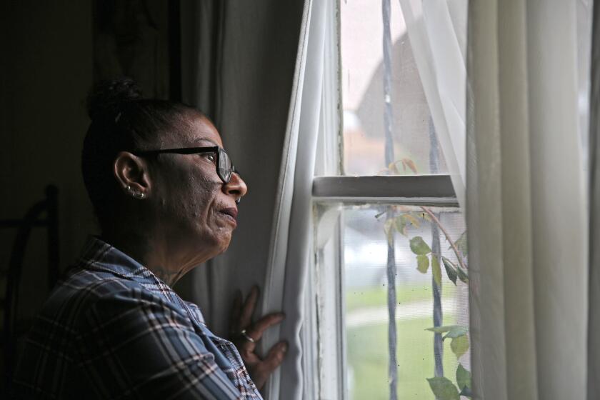 Deana Mirabal, 61 of Los Angeles, poses for a photo as she looks out a window of a reintegration home she lives in, in Los Angeles on Sunday, April 16, 2023. Mirabal spent almost 40 years incarcerated, according to her, for a murder she did not commit.
