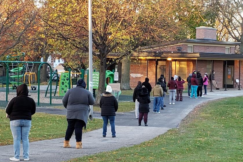 FILE - Voters wait in line outside a pavilion at Center Street Park shortly before the polling site opened on Election Day, Nov. 3, 2020, in Milwaukee. An audio recording of a strategy meeting obtained Thursday, Feb. 2, 2023, by The Associated Press shows, that the leaders of then-President Donald Trump's reelection campaign in battleground Wisconsin conceded privately the day after the 2020 election that he had lost, praising Democratic turnout efforts and focusing instead on spreading the lie that Democrats had stolen the election. (AP Photo/Rich Rovito, File)