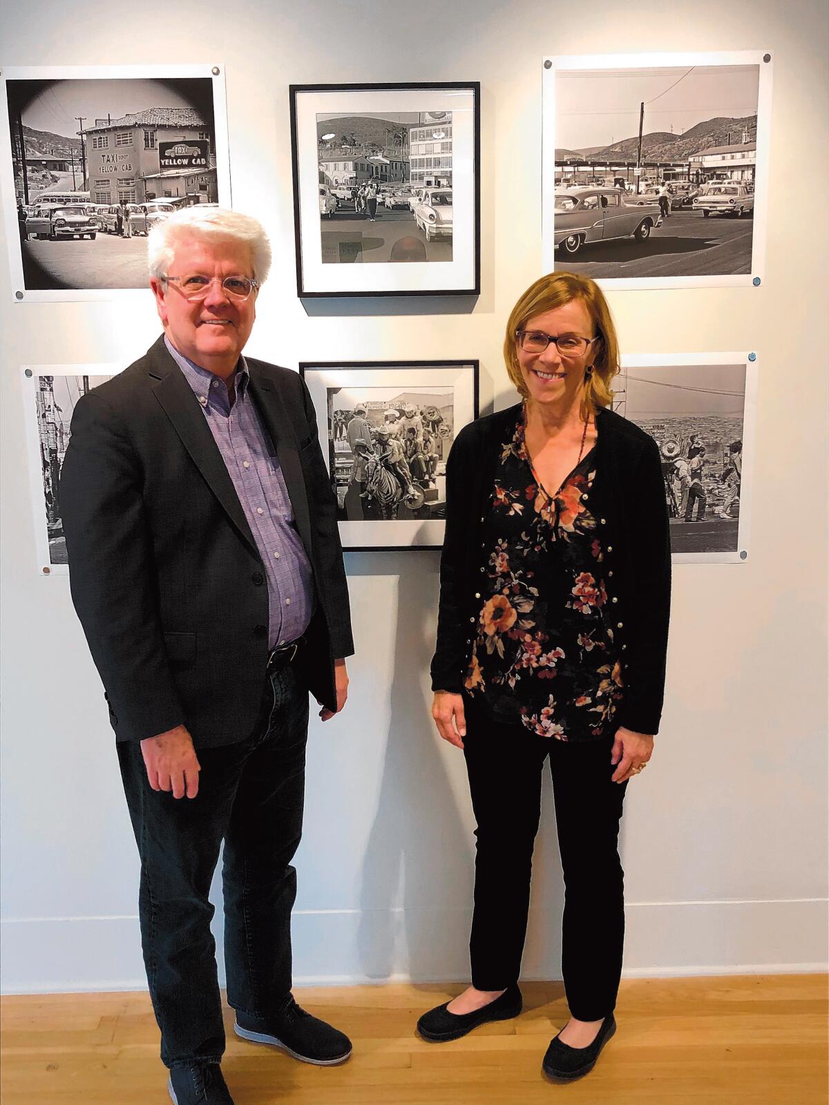 Heath Fox, La Jolla Historical Society executive director, and Melanie Showalter, exhibit curator of ‘Tijuana 1964: The Photography of Harry Crosby’
