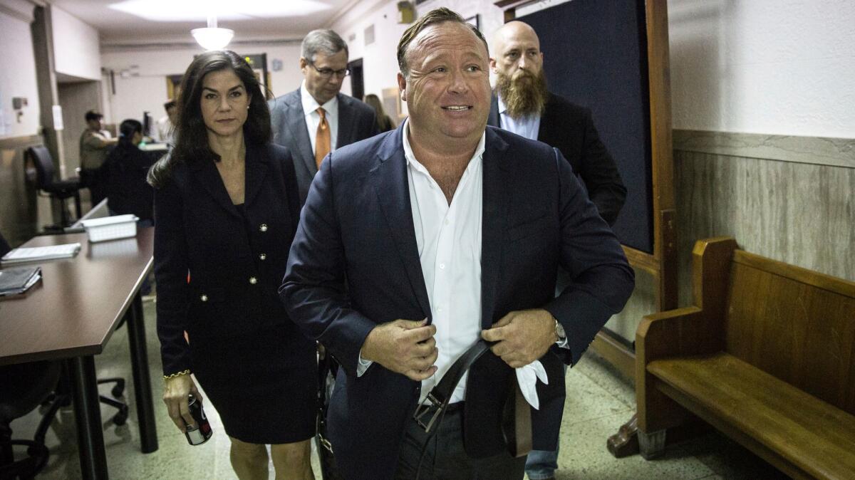 InfoWars host Alex Jones arrives at the Travis County Courthouse in Austin, Texas, for a child custody trial.