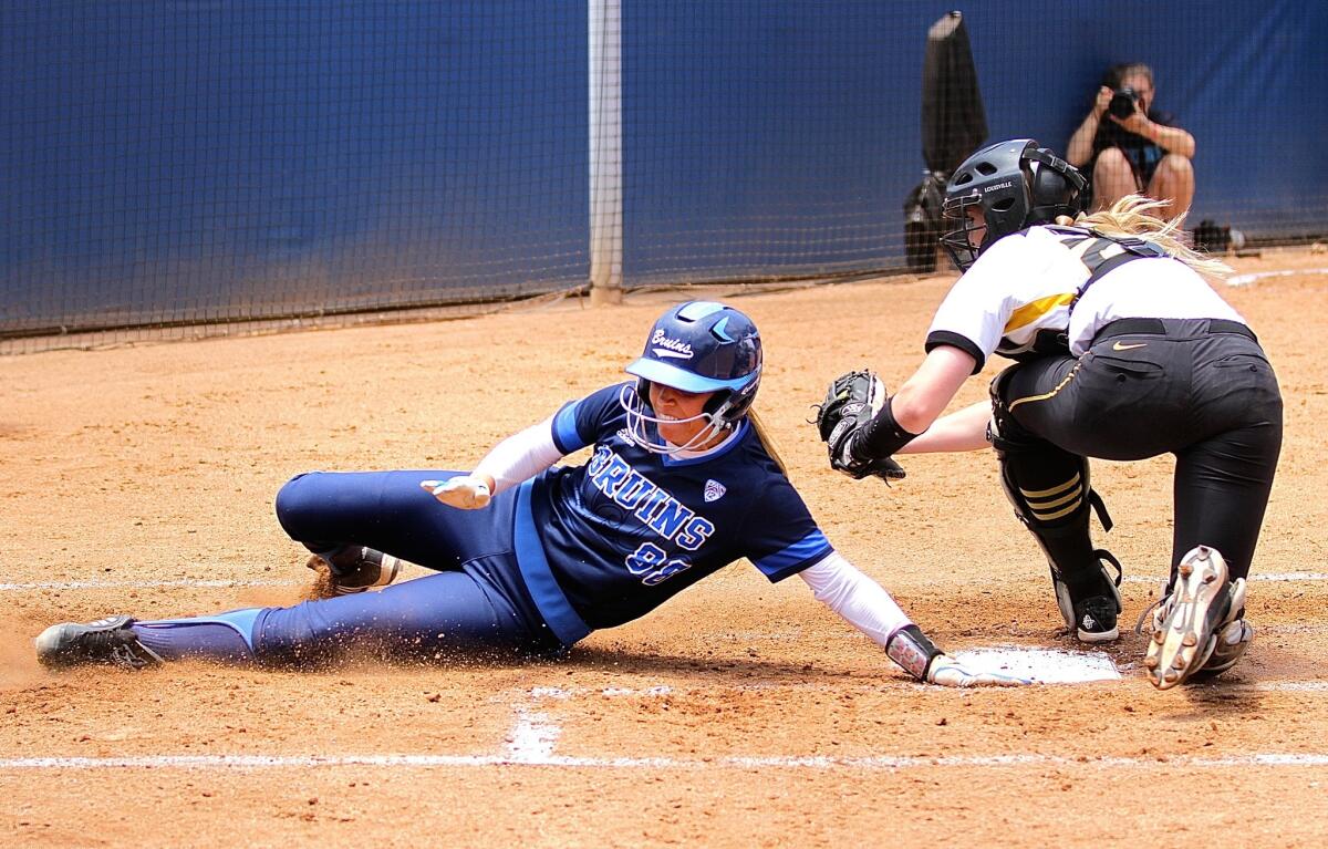 UCLA's Maddy Jelenicki slides home ahead of the tag from Missouri catcher Kirsten Mack in the second inning of Sunday's Super Regional game at Easton Stadium.
