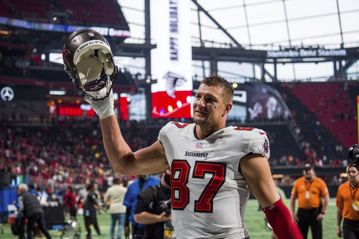 Tampa Bay Buccaneers tight end Rob Gronkowski waves to fans as he walks off the field.