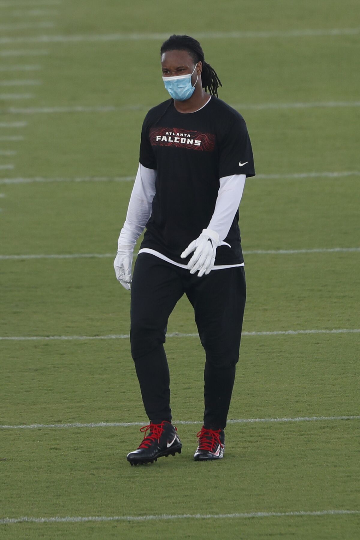 Atlanta Falcons running back Todd Gurley wears a protective face covering between drills during a strength and conditioning NFL football workout Monday, Aug. 3, 2020, in Flowery Branch, Ga. (AP Photo/John Bazemore, Pool)
