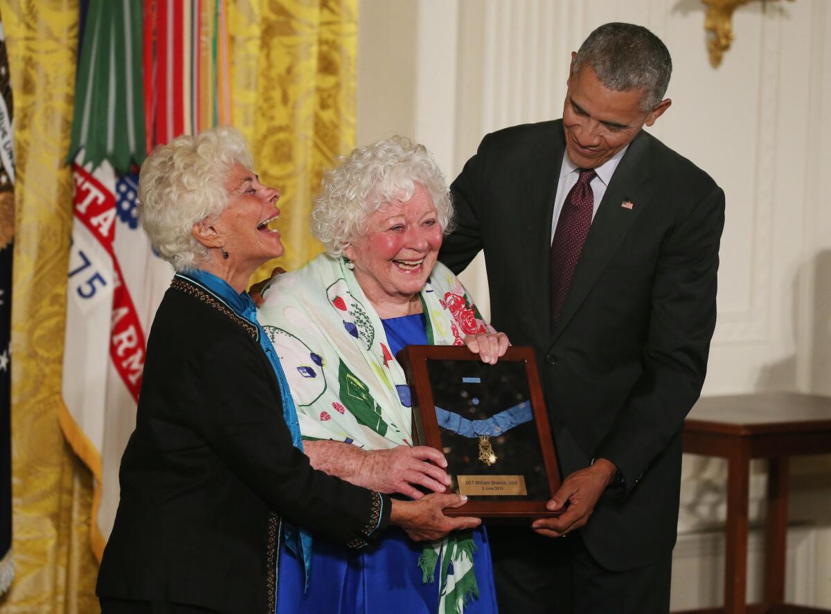 President Obama presents the Medal of Honor to Elsie Shemin-Roth, center, and Ina Bass, accepting on behalf of their late father, Army Sgt. William Shemin, for his actions during World War I. Obama also awarded a Medal of Honor to the late Army Pvt. Henry Johnson.