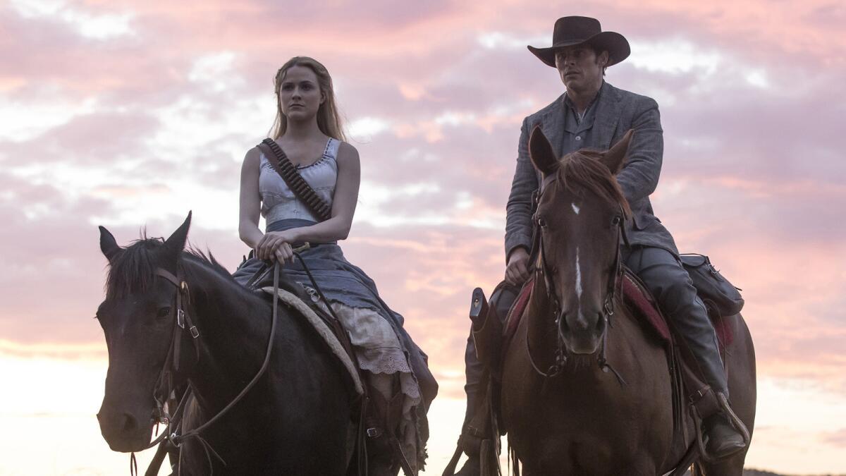 Evan Rachel Wood and James Marsden ride horseback in "Westworld."