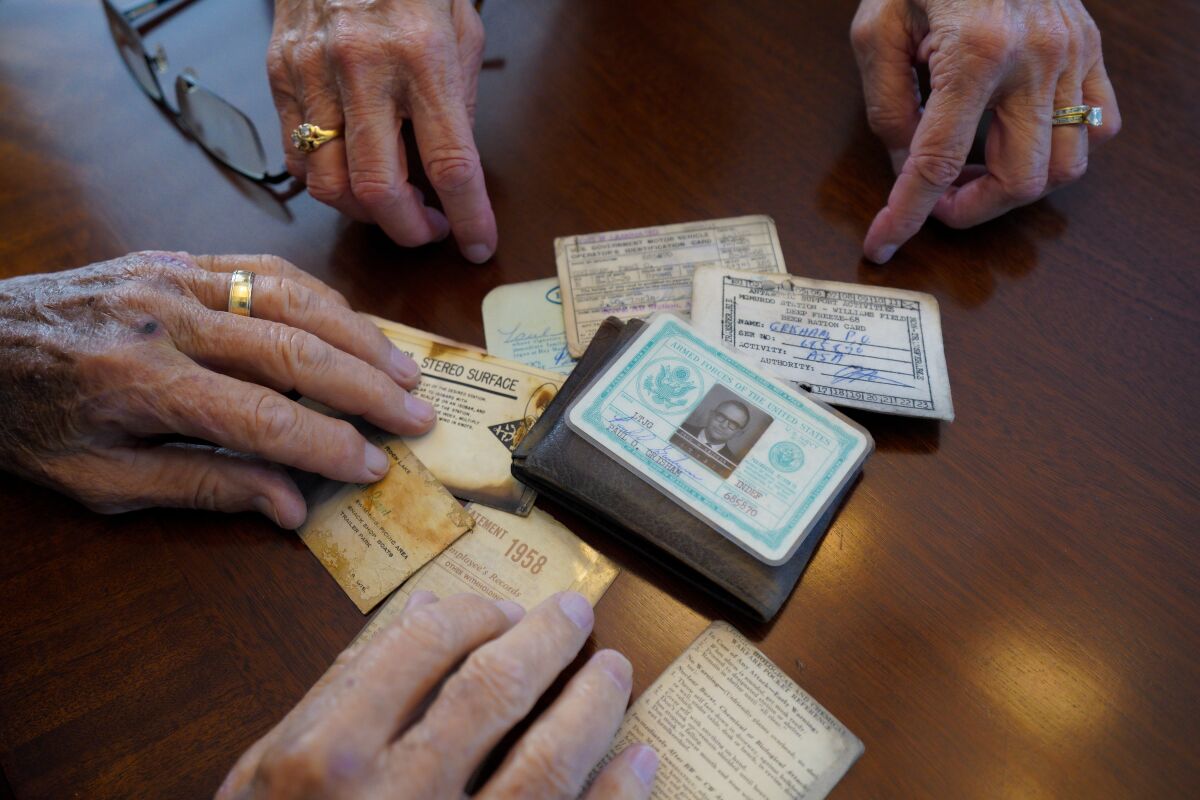  Paul Grisham and his wife, Carole Salazar, look over his wallet he lost in Antarctica.