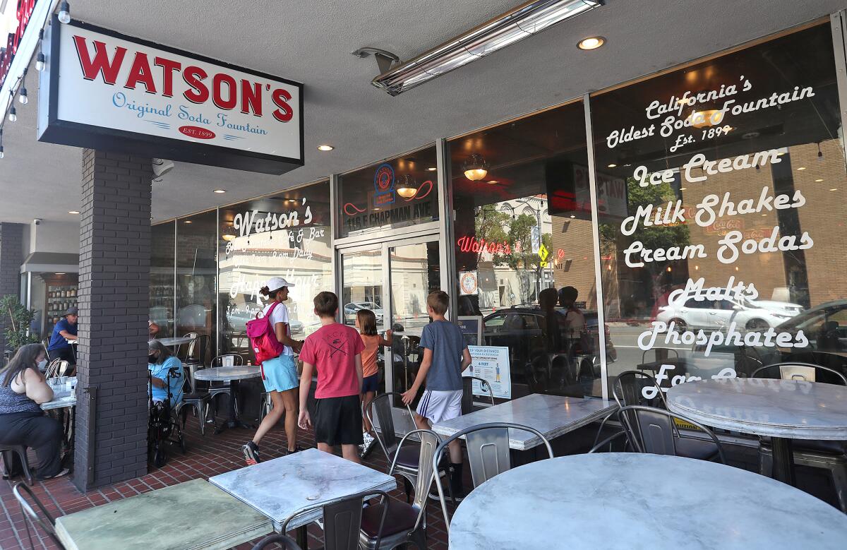A family walk into Watson's Soda Fountain & Cafe in Orange on Monday.