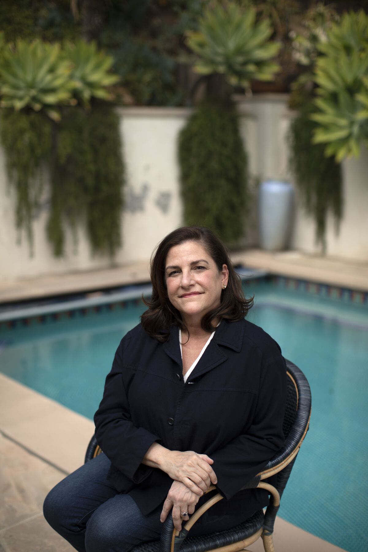 Author Cynthia D'Aprix Sweeney sits beside the swimming pool at her family's Los Feliz home.