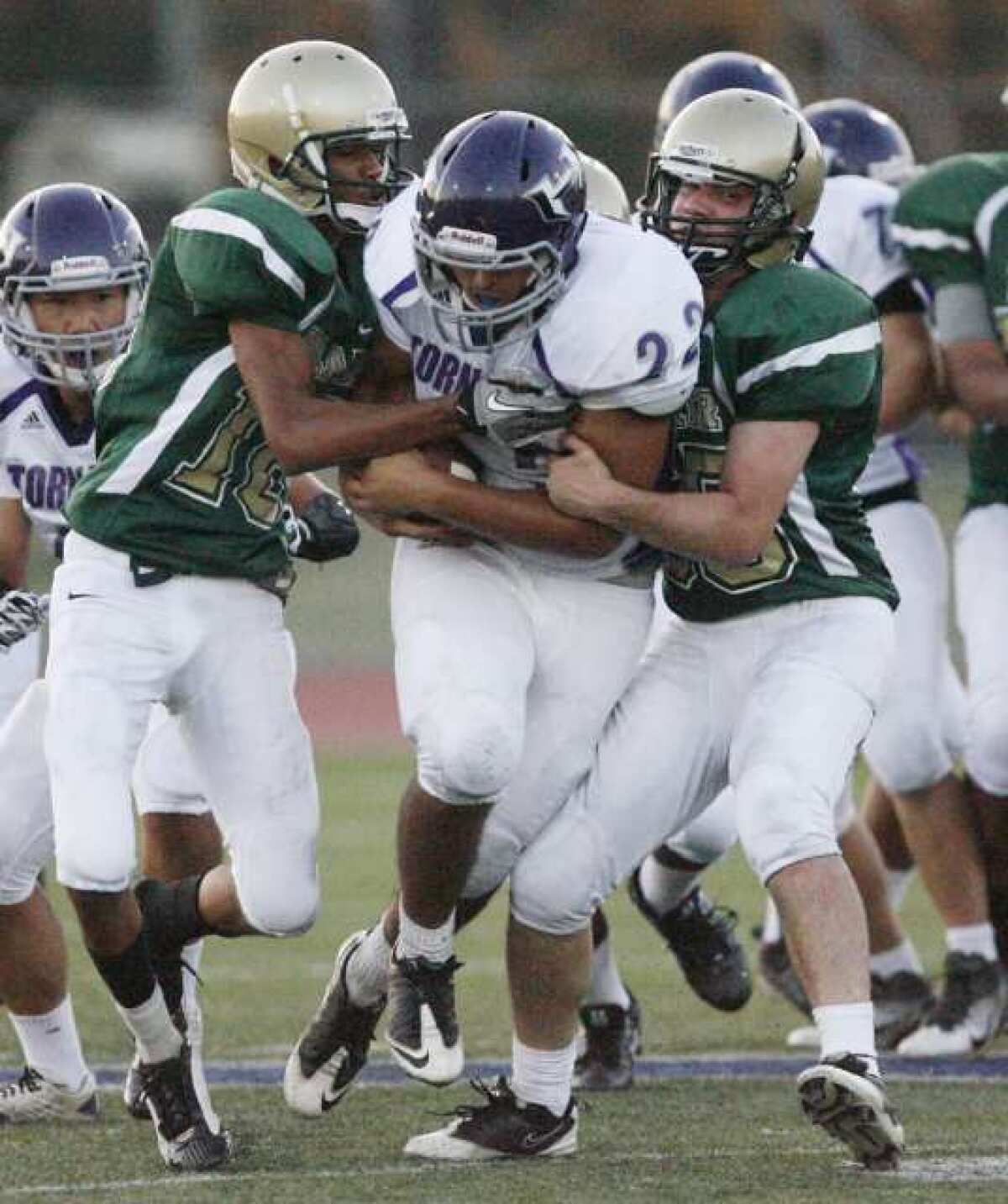 Hoover's Jesse Pina plows through two Blair tacklers.