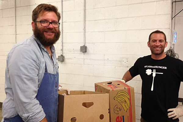 Providence chef Michael Cimarusti and barbecue king Adam Perry Lang haul boxes of sorted produce.