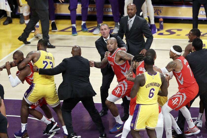 Houston Rockets' Chris Paul, far left, is held back by Los Angeles Lakers' LeBron James, second from left, after Paul fought with Lakers' Rajon Rondo, far right, during the second half of an NBA basketball game Saturday, Oct. 20, 2018, in Los Angeles. The Rockets won, 124-115. (AP Photo/Marcio Jose Sanchez)