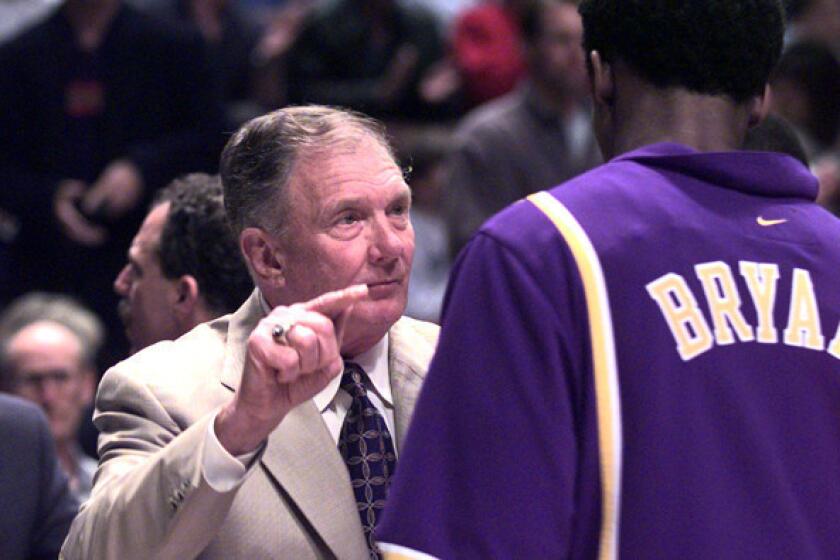 Bill Bertka, serving as Lakers interim coach, talks to then rookie guard Kobe Bryant before a game against the Clippers.