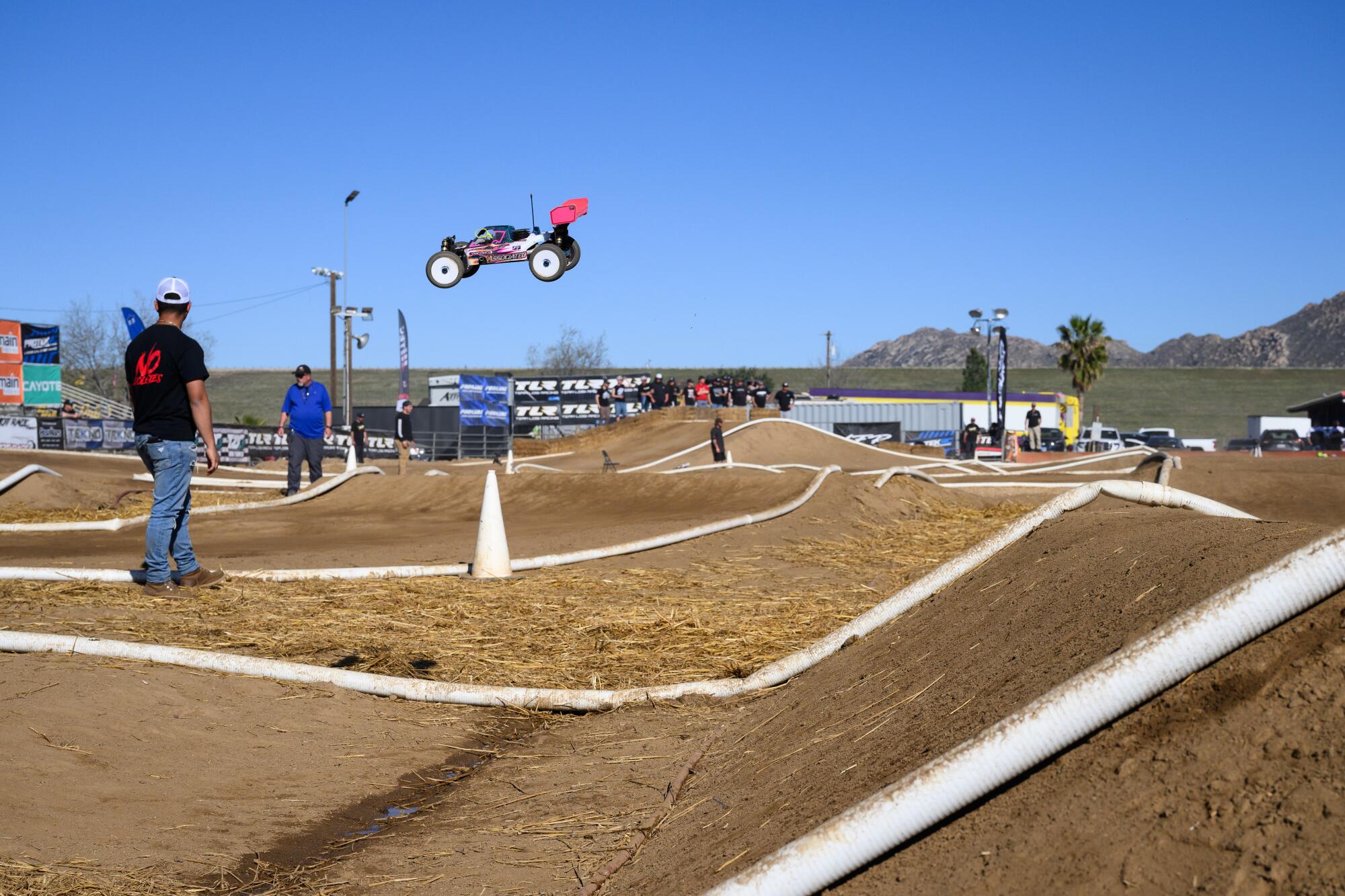 An RC car completes a jump on the track