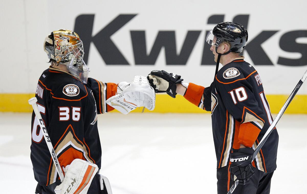 Ducks forward Corey Perry (10) and goalie John Gibson (36) celebrate a 4-2 win against the Flyers.