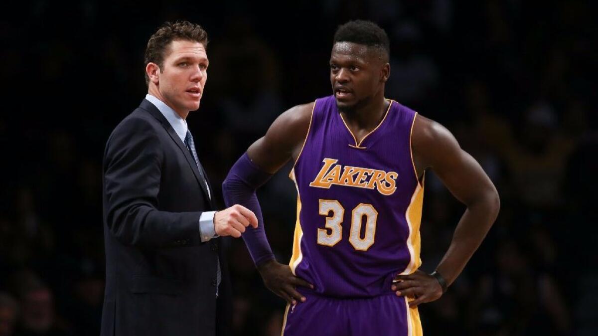 Lakers forward Julius Randle, here with Coach Luke Walton, doesn't want to miss the birth of his son.