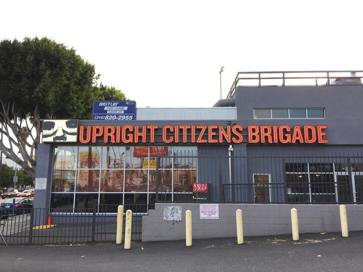 Grey building with sign that says Upright Citizen's Brigade 