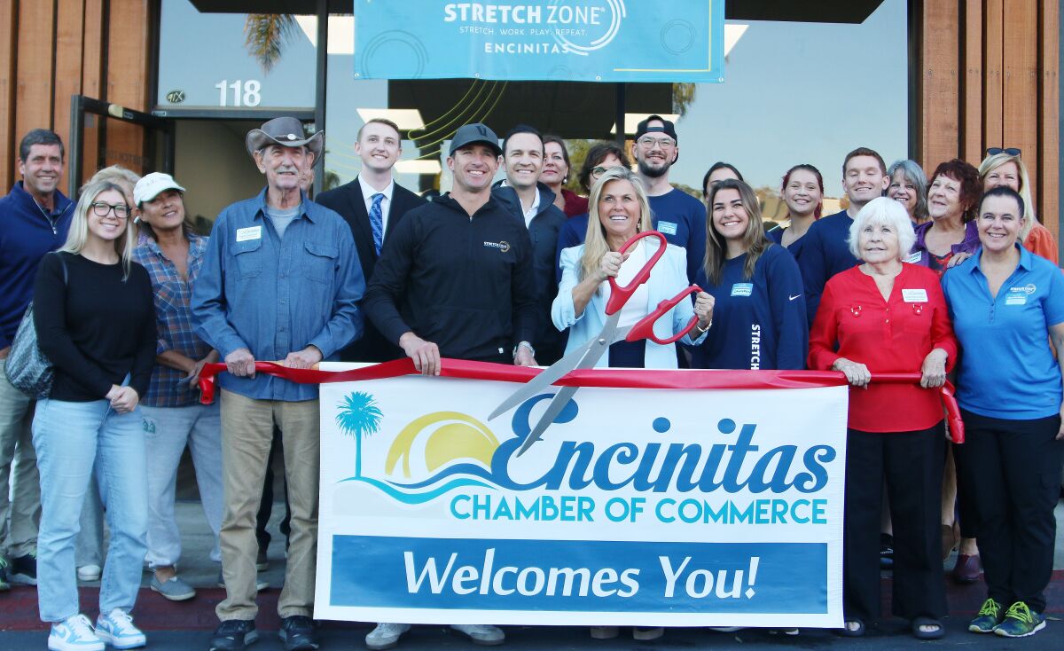 Preparing for the ribbon cutting at the recent "grand re-opening" of Encinitas Stretch Zone.