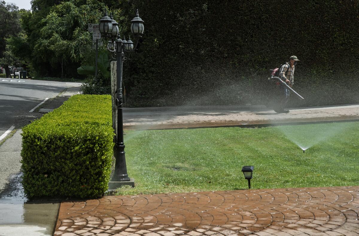 A gardener tends to the front yard. 