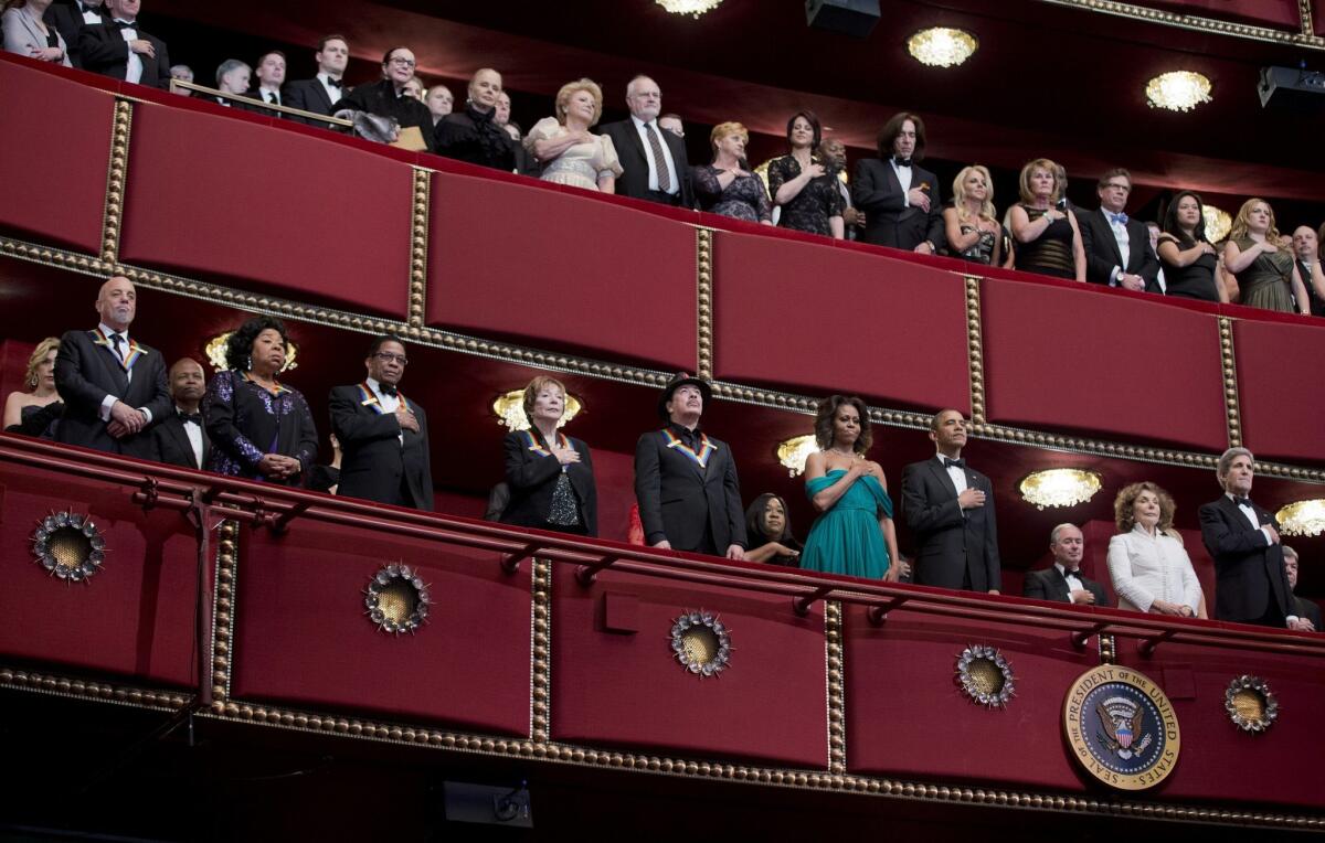 he recipients of the 2013 Kennedy Center Honors Billy Joel,from left, Martina Arroyo, Herbie Hancock, Shirley MacLaine, and Carlos Santana, together with first lady Michelle Obama, President Barack Obama, Teresa Hines, and Secretary of State John Kerry, listen as the National Anthem is played during the 2013 Kennedy Center Honors Gala at the Kennedy Center.