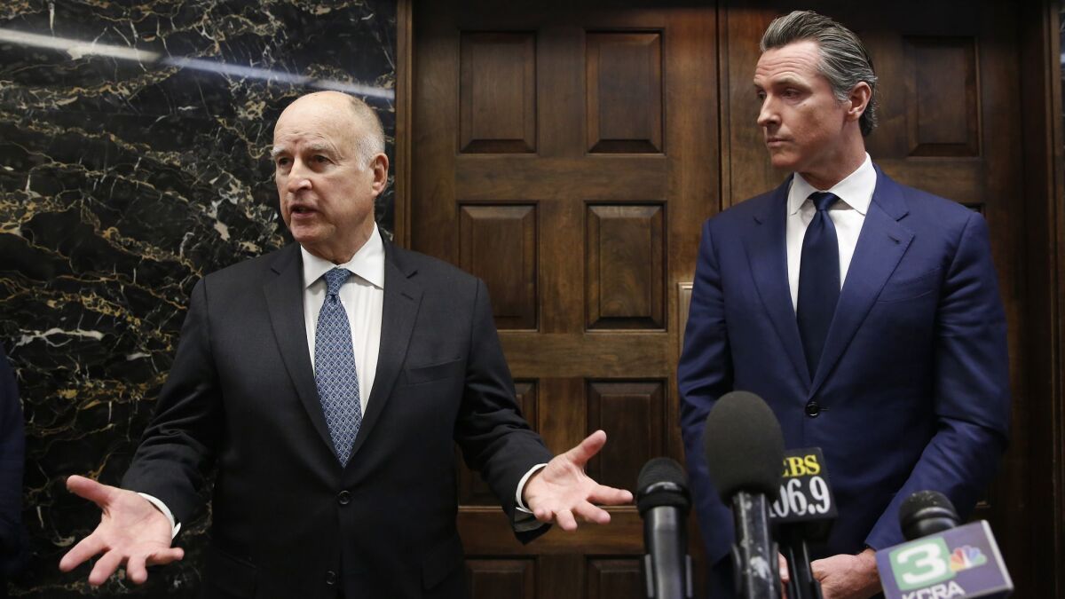 Gov. Jerry Brown, left, responds to a reporter's question following a meeting with Governor-elect Gavin Newsom in Sacramento, Calif. on Nov. 13.