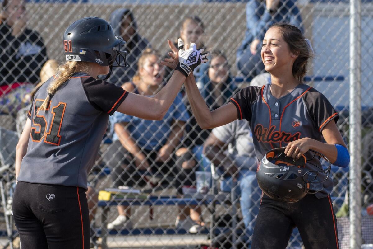 Huntington Beach's Shelbi Ortiz is given the run on an obstruction call at the plate in a CIF Southern Section Division 1 quarterfinal game on May 24, 2018.