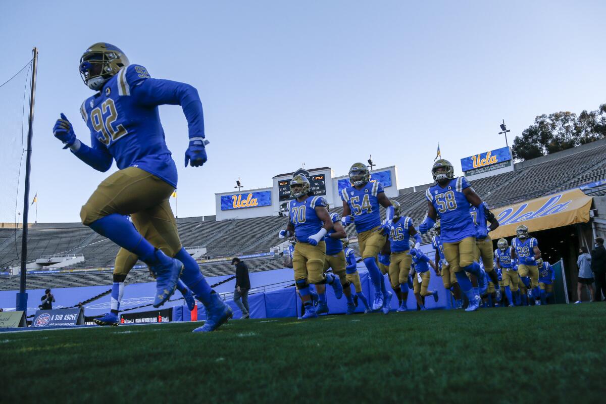 UCLA players run out of the tunnel before a game against Stanford.