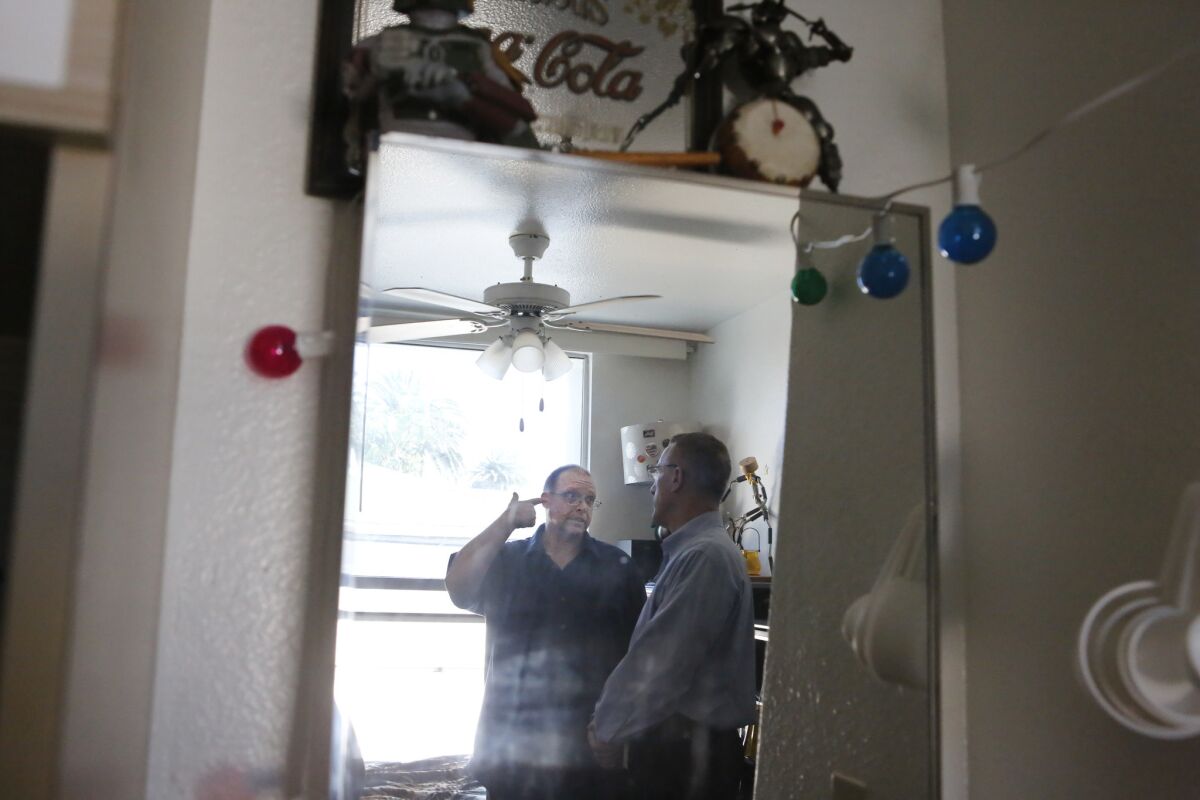 Theo Robin, left, discusses his life with Pennsylvania Rep. Timothy F. Murphy at Robin's apartment. (Christian K. Lee / Los Angeles Times )
