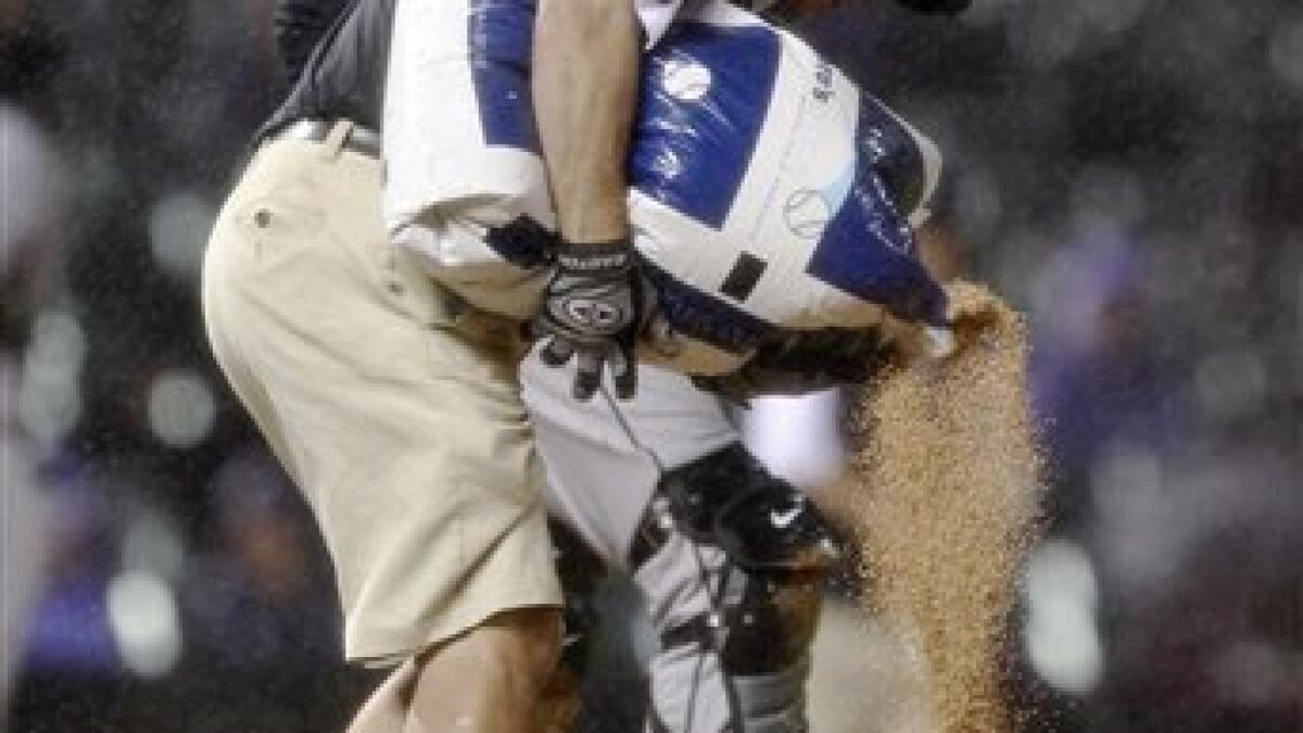 Colorado Rockies' Miguel Olivo, left, follows the flight of his