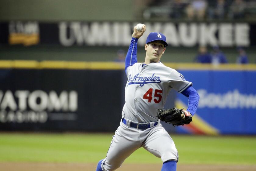 Dodgers starter Joe Wieland throws during the first inning against the Brewers. He allowed five runs in the inning.