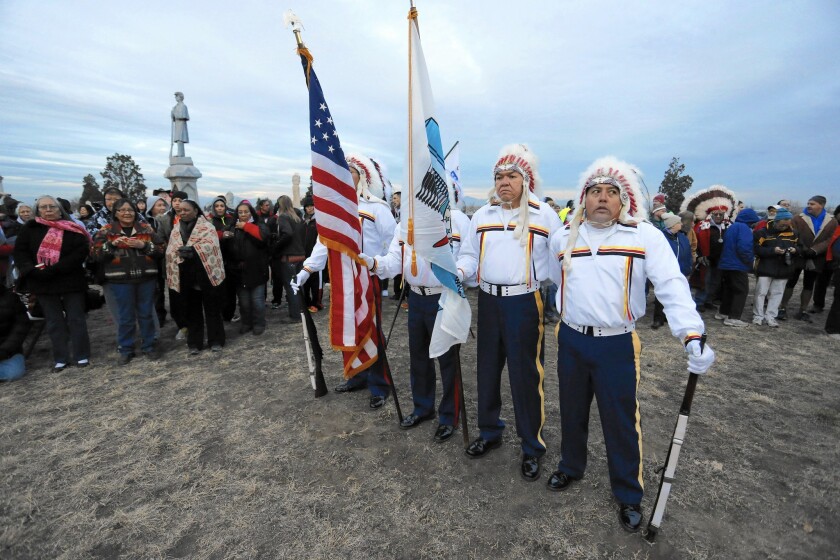 Members of an Arapaho and Cheyenne honor guard mark the Sand Creek Massacre’s 150th anniversary at Riverside Cemetery in Denver, resting place of Capt. Silas Soule, who exposed the atrocity.