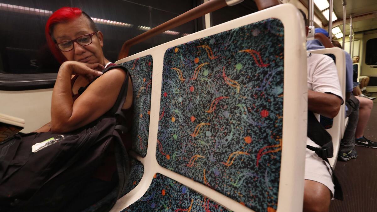 Cindy Solorzano of Van Nuys rides the Metro Red Line, sitting on a cloth seat. Metro is planning to install vinyl seats on the subway, saying plastic-based fabrics are non-absorbent, cheaper to install and much easier to keep clean.