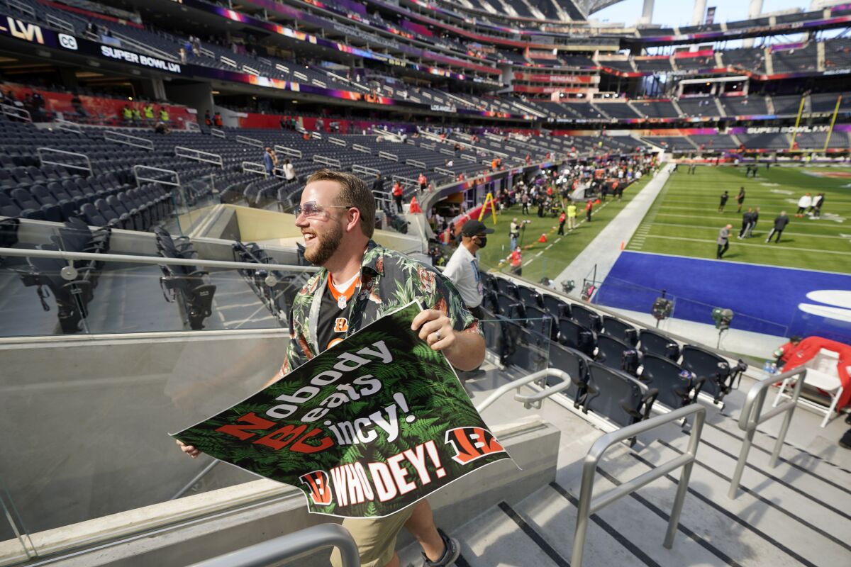 A Cincinnati Bengals fan walks to his seat before Super Bowl LVI begins. 