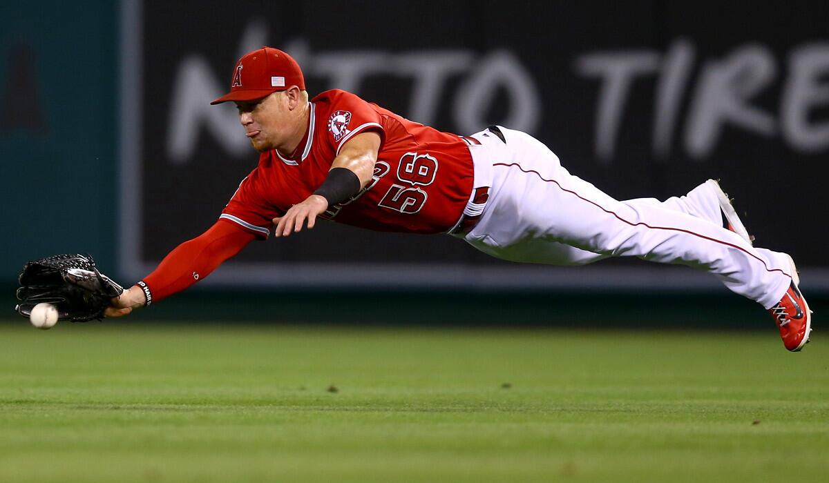 Angels right fielder Kole Calhoun makes a diving attempt to catch a fly ball by Astros second baseman Jose Altuve in the second inning Friday night but comes up short.