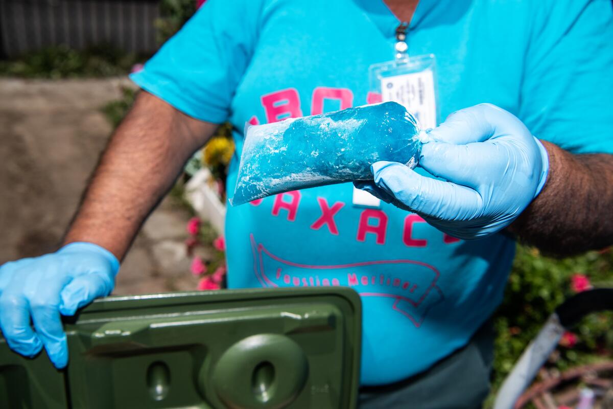 Faustino Martinez showcases some of the flavored ice cream he makes and sells in his South L.A. neighborhood. 