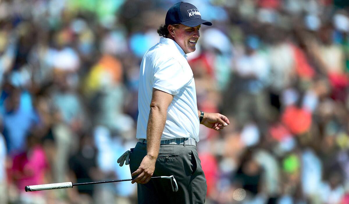 Phil Mickelson is all smiles on the 18th green during the third round of the Wells Fargo Championship on Saturday.