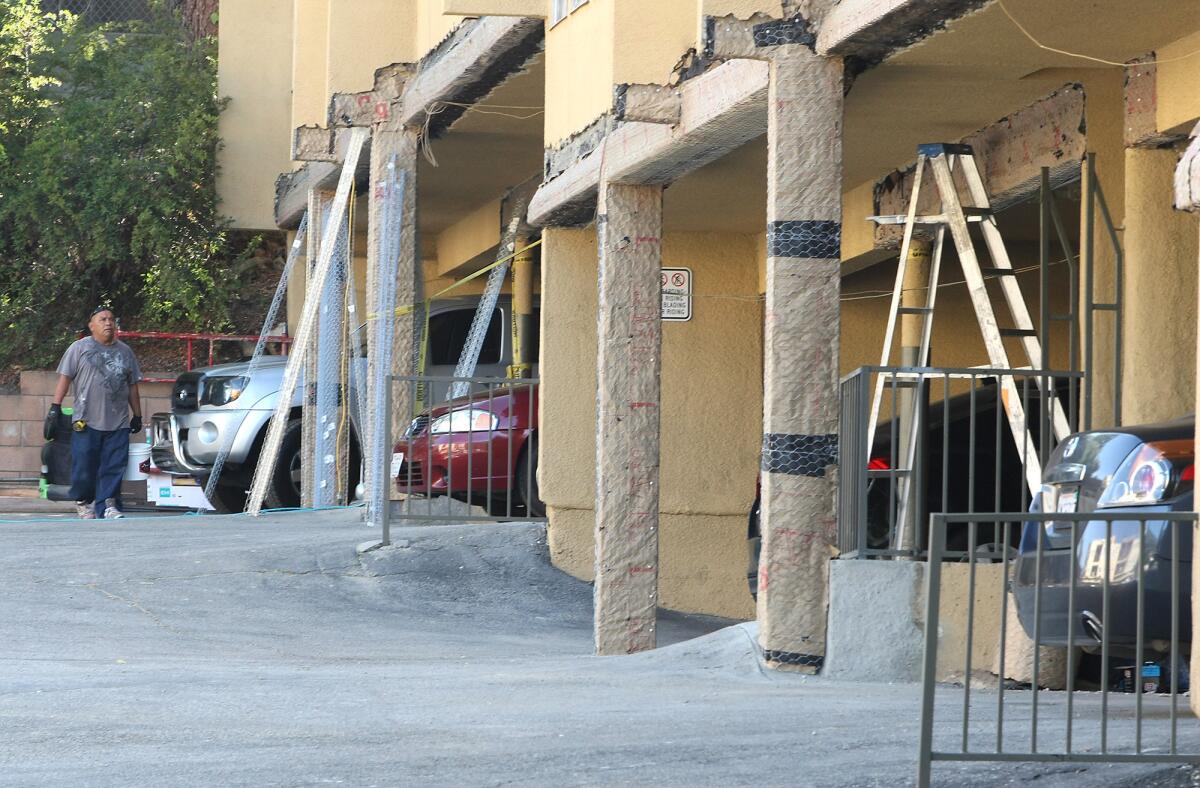Construction workers seismically retrofit an apartment building in Montrose on Friday.