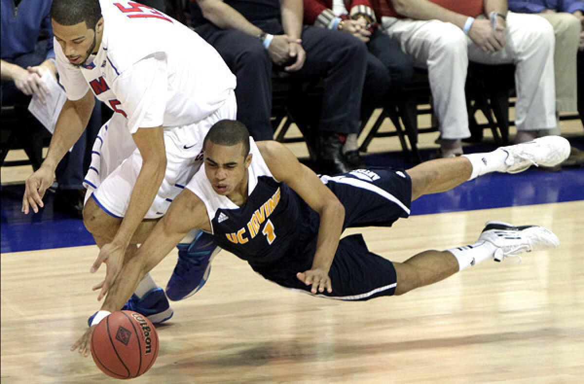 UC Irvine guard Alex Young dives in an attempt to beat Southern Methodist's Cannen Cunningham to a loose ball during the first half of an NIT game on Wednesday night.