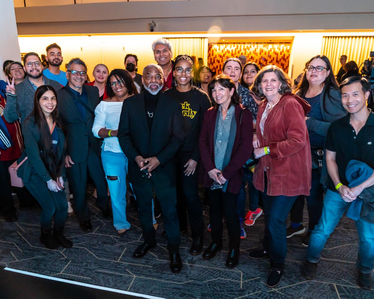 Actor and author LeVar Burton takes a photo with book club readers.