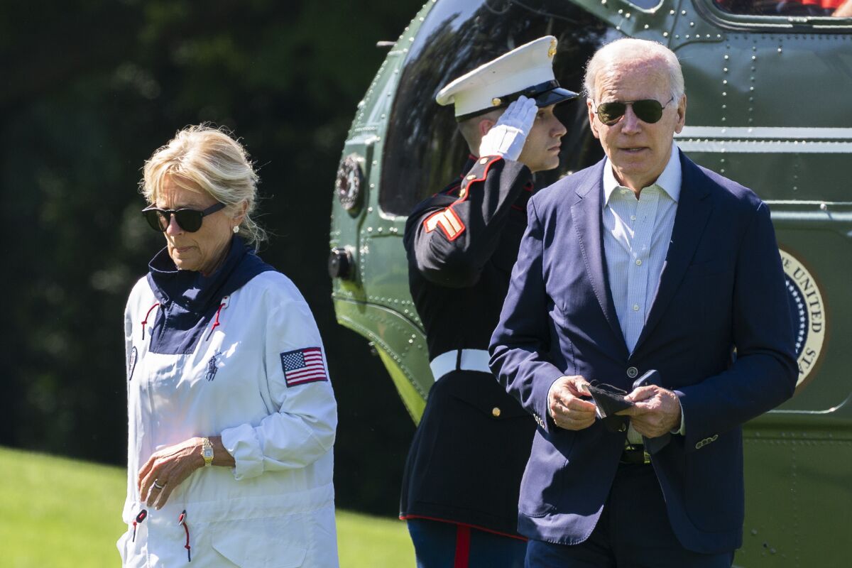President Joe Biden and first lady Jill Biden walk on the South Lawn upon arrival at the White House from Rehoboth Beach, Del., Sunday, June 5, 2022, in Washington. (AP Photo/Manuel Balce Ceneta)