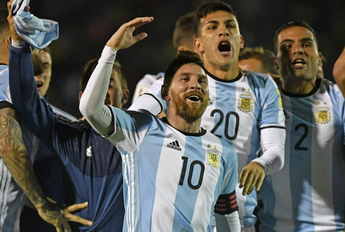 Argentina's Lionel Messi (C) celebrates after defeating Ecuador and qualifying to the 2018 World Cup football tournament, in Quito, on October 10, 2017.