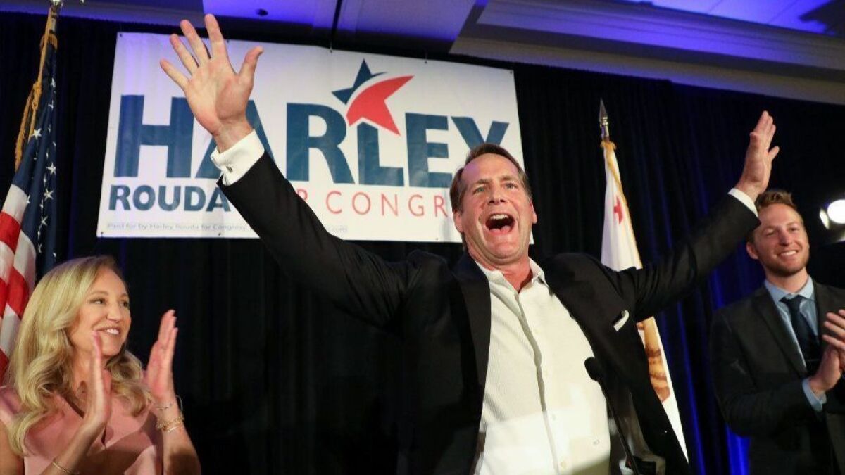 Democratic candidate Harley Rouda, who leads longtime incumbent Republican Dana Rohrabacher, waves to supporters on election night at the Newport Beach Marriott Hotel.