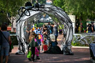 LOS ANGELES, CA - OCTOBER 30: Families walk down the spider web tunnel at the 3rd annual Boonion Station, a free, two-day, family-friendly Halloween hoopla at the iconic Union Station on Saturday, Oct. 30, 2021 in Los Angeles, CA. (Jason Armond / Los Angeles Times)