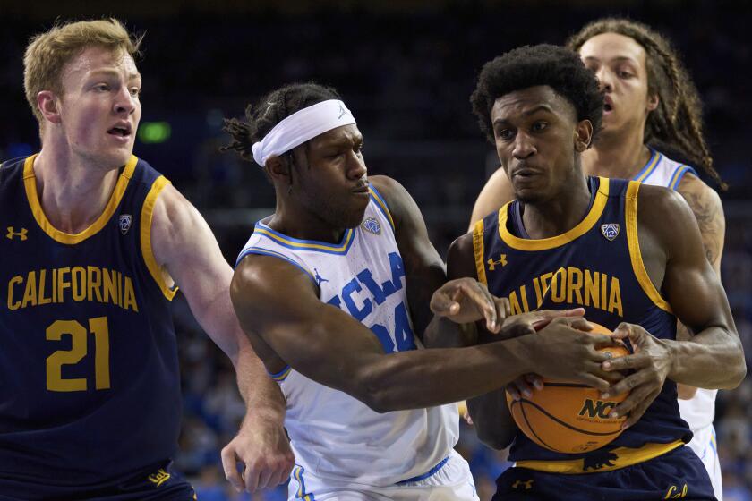 UCLA guard David Singleton tries to steal the ball from California guard Marsalis Roberson.