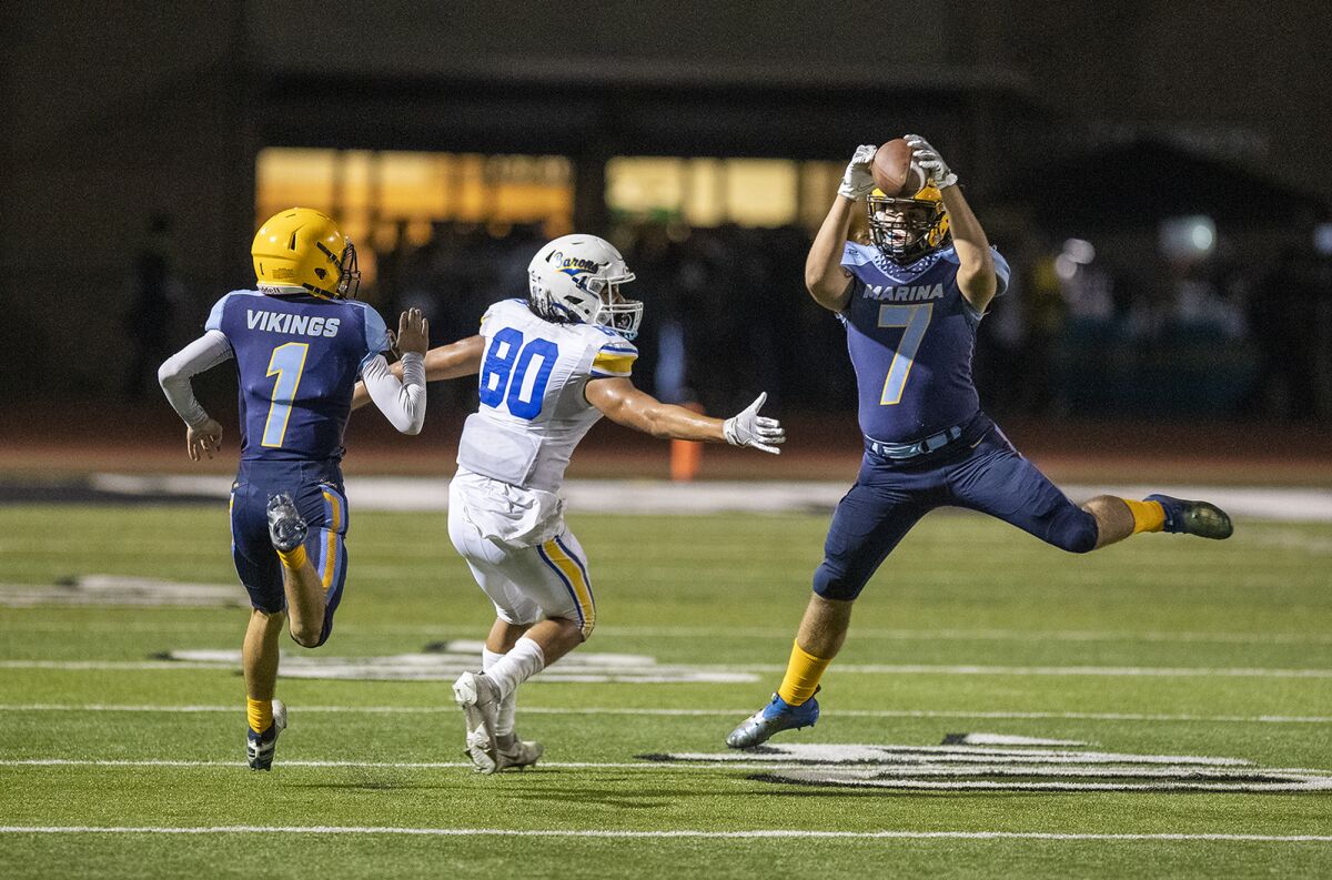 Marina's Cade Jackman intercepts a pass intended for Fountain Valley's Drew Reyes  at Westminster High School on Friday.